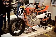 Left-side view of an orange and white racing motorcycle taken at The One Motorcycle Show in Portland, Oregon