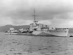 a black-and-white photograph of a warship at sea