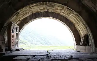 Monastery gate, looking from inside out; note stone crosses (khachkars) left and right