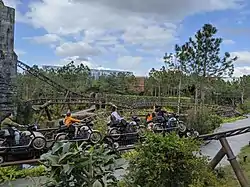 Several people riding the Hagrid's Magical Creatures Motorbike ride, as seen from the queue