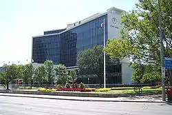 A tall building surrounded by greenery