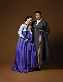 A woman and man wearing traditional Korean hanbok