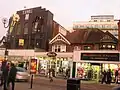 Middle section of Station Road, showing shops and the Time Building and apartments on Lyon Road behind it