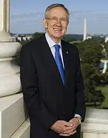 An elderly Reid in suit and tie smiling