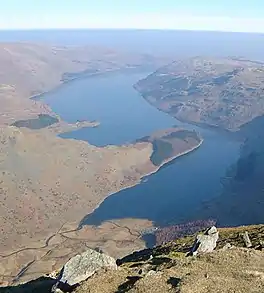 A large lake deep in a valley, pictured from high above