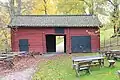 Hewn log barn painted red in Hedemora, Sweden.