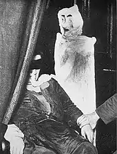 Duncan with alleged ectoplasm figure made from a coat-hanger, cloth and a mask