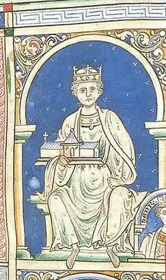 An image of King Henry II, portraying him in all white on a blue background.  King Henry is sitting, holding a church.  He has a royal crown on his head.