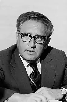 A black and white photograph of Henry Kissinger