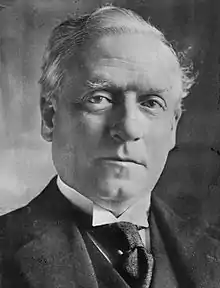 Studio portrait of older man, very well dressed with determined expression