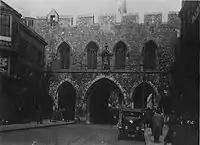 The Bargate from the south c. 1930, flanked by buildings and with tram lines running through the arch