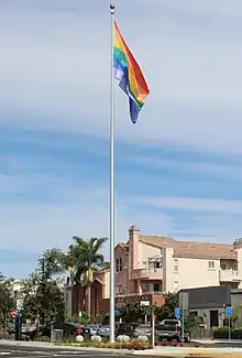 Rainbow flag on a tall flagpole