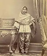 Girl from Karachi, Sind, in narrow Sindhi Soossi suthan and cholo. c. 1870.