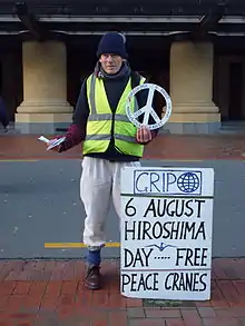 An anti-nuclear activist hands out peace cranes in Wellington. New Zealand's foreign policy is often symbolised by its anti-nuclear stance.