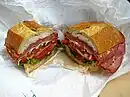 A submarine sandwich, which includes a variety of Italian luncheon meats