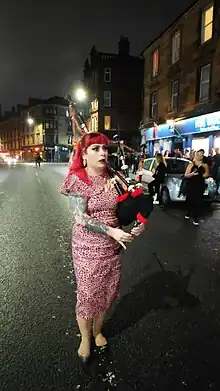 Hogmanay reveller piping in the New Year in Queen's Park, Glasgow - December 2023