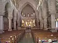 Interior of nave, with fans in pews