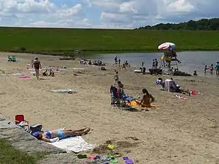 Swimming beach in bathing pond below dam