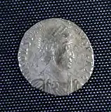 A smaller silver coin in the centre a head - still a fairly round coin but the inscription is not intact and there is no space between it and the rim