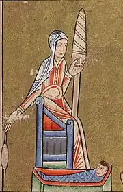 Woman, wearing red and with a white headdress, using a spindle and distaff. She is also caring for a child.