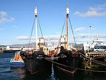 Two moored vessels. Both have significant amounts of rust