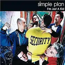 Simple Plan ganging up on a man wearing a yellow shirt with the word "Security" on the back.