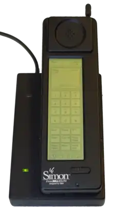 Photograph of the Simon Personal Communicator shown in its charging base