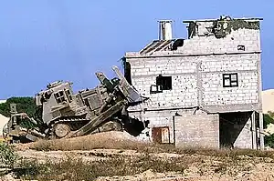 IDF Caterpillar D9L razing a Palestinian house