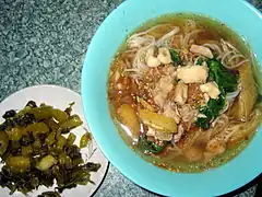 Shan hkauk swè (Shan rice noodles) with to hpu gyaw (tofu fritters) served with monnyingyin (pickled mustard greens) on the side