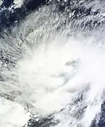 A tropical disturbance with clouds wrapping cyclonically around a center