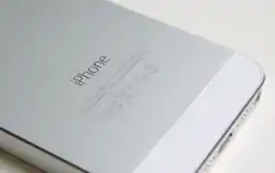 The "iPhone" wordmark on the back of an iPhone 5s.