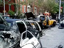 Burnt and abandoned car props are situated near post-apocalyptic Washington Square Park in New York City as part of a set for the film I am Legend.