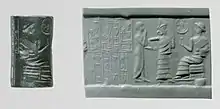 Ibbi-Sin cylinder seal, with Ibbi-Sin enthroned. Inscription: "Ibbi-Sin the strong king, king of Ur, King of the four quarters [of the world] // Ilum-bani the overseer, son of Ili-ukin [is] your servant".