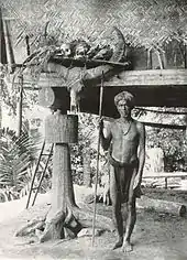 An Ifugao warrior with some of his trophies, Philippines, 1912