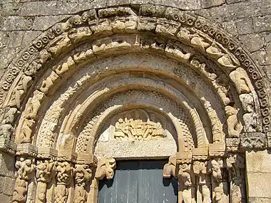 Tympanum of the church of São Salvador de Bravães, Christ surrounded by two of His disciples.