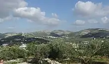 Ijnisinya in the center. On the left are the houses of Sebastia. Hidden behind the antenna is Nisf Jubeil and Zawata behind the mountain on the right side followed by the city of Nablus.