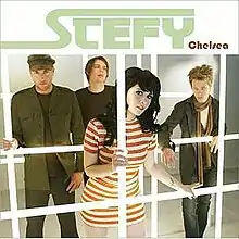 The four members of Stefy stand behind computerized jail bars, with the lead singer, Stefy Rae, standing in the center front.