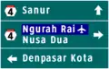 4-way directional sign. Ngurah Rai International Airport is highlighted in blue as it is a public facility