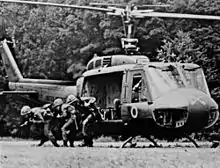 1st Air Cavalry troopers exit a Huey chopper in Vietnam.