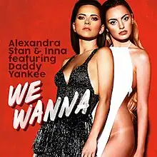 Stan and Inna posing close to each other in front of a red backdrop, sporting the outfits used for the single's music video.