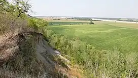 Side view of the Ionia Volcano overlooking a field