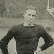 Player in dark jersey, hands on hips