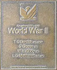 an image of a bronze plaque listing highly decorated service personnel of World War II