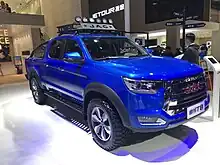 A blue pickup truck with a "JAC" badge (large Latin letters) at the front grille. On the license plate, instead of an actual registration, the model name is displayed: Chinese characters for "Shuailing", followed by "T8" (Latin letter and number)