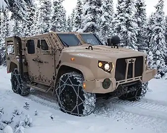 A production standard USMC JLTV in M1280 General Purpose (GP) configuration, this example fitted with a deep fording kit and tire chains.