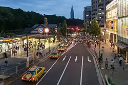 Harajuku Station (left), with Meiji Shrine forest as background