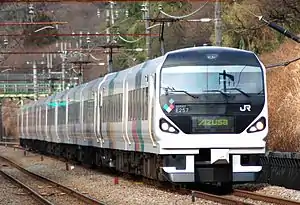 White train with black front and colorful sides