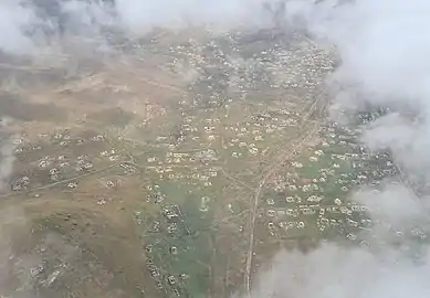 Aerial view of the ruined city, showing destroyed houses