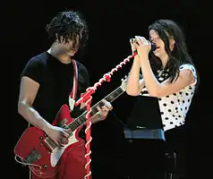 Colour photograph of Jack and Meg White performing live in 2007