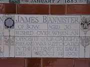 A tablet formed of five tiles of varying sizes, bordered by yellow and blue flowers in an art nouveau style